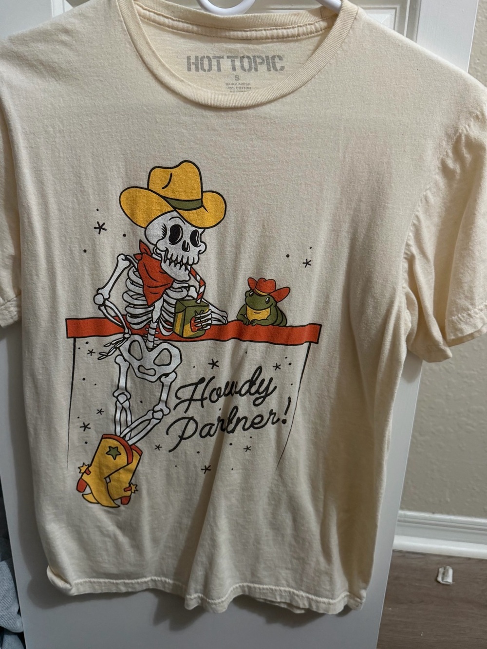 Hot Topic Cream Cowboy Skeleton Graphic Tee with Yellow & Red Accents